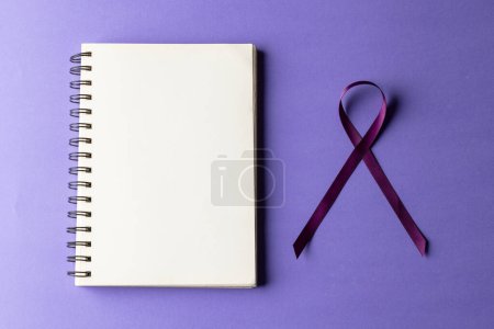 Photo for Purple add or adhd awareness ribbon and notebook with copy space, on purple background. Medical services, healthcare and mental health awareness concept. - Royalty Free Image