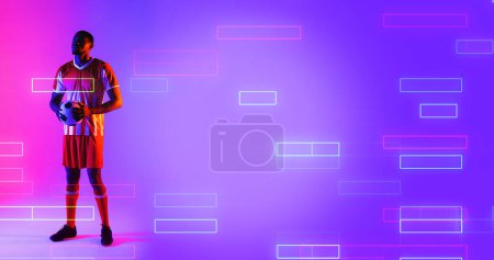 Photo for African american male soccer player holding ball and standing over illuminated rectangles. Copy space, composite, sport, competition, shape, playing, match, neon and abstract concept. - Royalty Free Image