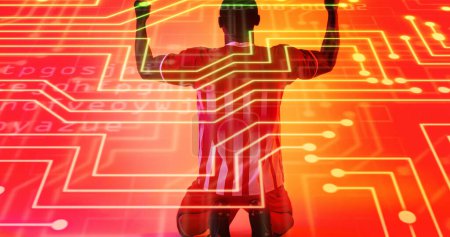 Photo for Rear view of african american male player kneeling and raising arms over connected dots and letters. Composite, illuminated, sport, competition, winner, soccer, match, neon, coding and abstract - Royalty Free Image