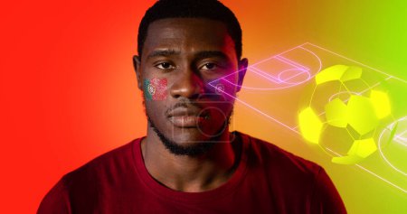 Photo for Portrait of african american man with portuguese flag's face paints by digital soccer field and ball. Copy space, composite, sport, fan, competition, support, serious, match, neon, patriotism - Royalty Free Image