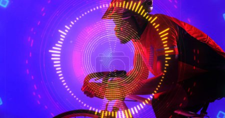 Illuminated circular pattern over african american man wearing glasses and helmet riding bike. Copy space, composite, sport, cycling, racing, competition, shape, neon, protection and abstract concept.