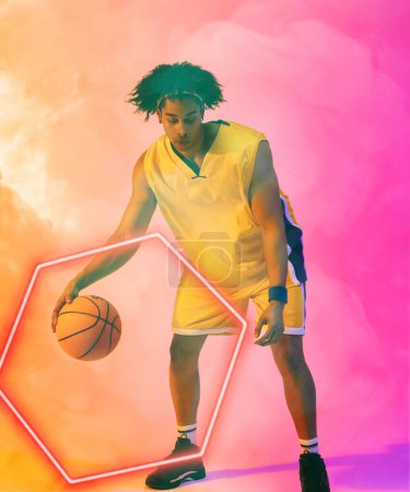 Photo for Composite of biracial male player dribbling basketball by glowing hexagon against smoky background. Copy space, pink, sport, competition, illustration, illuminated, shape and abstract concept. - Royalty Free Image