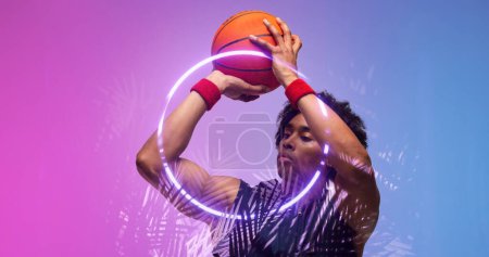 Photo for Composite of biracial basketball player throwing ball by illuminated plants and circle, copy space. Playing, sport, competition, illustration, glowing, nature, shape and abstract concept. - Royalty Free Image