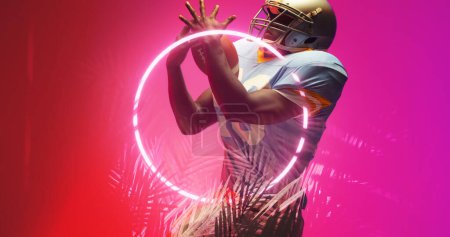 Photo for American football player catching ball while standing by illuminated circle and plants, copy space. Purple, composite, sport, competition, illustration, playing, glowing, nature, shape, playing. - Royalty Free Image