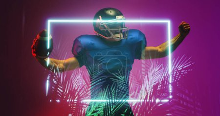 Photo for American football player raising arms while standing by illuminated rectangle and plants. Violet, achievement, happy, composite, sport, competition, illustration, glowing, nature, shape and abstract. - Royalty Free Image