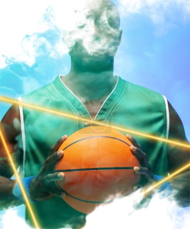Photo for African american basketball player holding ball by illuminated triangle against smoky background. Composite, copy space, blue, sport, competition, illustration, glowing, shape and abstract concept. - Royalty Free Image