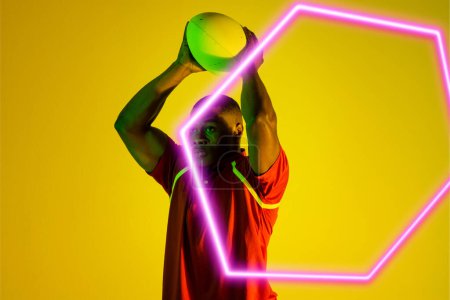 Photo for Hexagon neon over african american young rugby player playing against yellow background. Digital composite, sport, rugby, athlete, competitive sport, skill, playing, copy space. - Royalty Free Image
