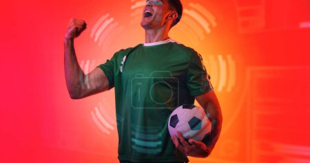 Photo for Composite of young caucasian soccer player celebrating victory with neon pattern in background. Copy space, computer graphic, soccer, design, athlete, sport, success. - Royalty Free Image