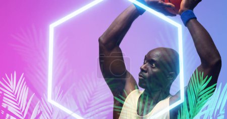 Photo for Bald african american basketball player with arms raised throwing ball by hexagon and plants. Composite, copy space, playing, sport, competition, illustration, illuminated, nature, shape, abstract. - Royalty Free Image