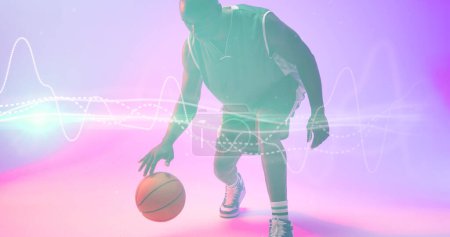 Photo for African american basketball player dribbling ball by illuminated wave patterned lines. Copy space. Composite, playing, sport, competition, illustration, shape and abstract concept. - Royalty Free Image
