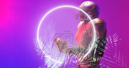 Photo for Side view of american football player wearing helmet holding ball by illuminated circle and plants. Purple, copy space, composite, sport, competition, illustration, glowing, nature, shape, abstract. - Royalty Free Image