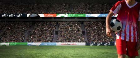 Photo for Midsection of player holding soccer ball standing at stadium, copy space. Soccer, sportsman, athlete, sport, competitive sport, match, skill, panoramic, vignette. - Royalty Free Image