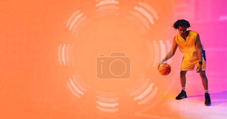 Photo for Composite of biracial basketball player dribbling ball by floral pattern, copy space. Sport, competition, illustration, glowing, shape and abstract concept. - Royalty Free Image