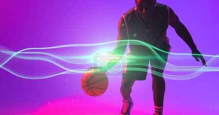 Photo for African american basketball player dribbling ball by wave patterned lines and lens flare. Copy space. Composite, playing, sport, competition, illuminated, illustration, shape and abstract concept. - Royalty Free Image
