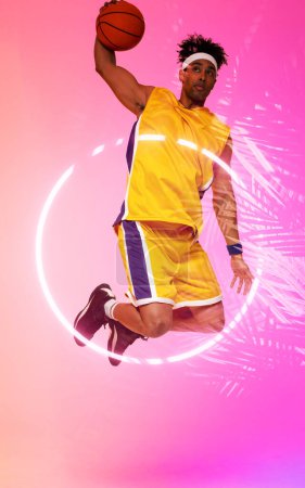Photo for Composite of biracial player jumping and taking a shot with basketball by circle and plants. Copy space, pink, sport, competition, illustration, illuminated, nature and shape concept. - Royalty Free Image