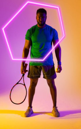 Photo for Hexagon neon over confident african american tennis player with racket against colored background. Digital composite, design, athlete, competitive sport, portrait, copy space, determination. - Royalty Free Image