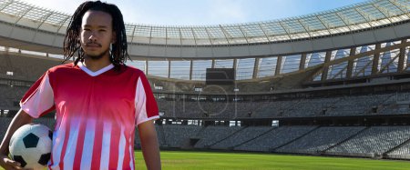 Photo for Portrait of confident african american soccer player with ball at stadium on sunny day, copy space. Sport, competitive sport, skill, athlete, confidence, panoramic. - Royalty Free Image