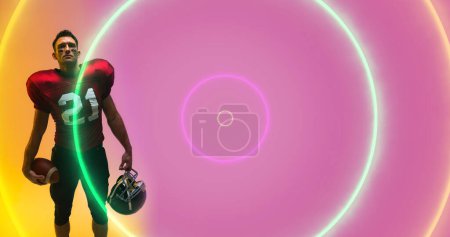 Photo for American football player in 21 number jersey with ball and helmet standing by multiple circles. Copy space, composite, illuminated, sport, competition, match, illustration and abstract concept. - Royalty Free Image