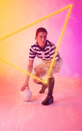 Photo for Caucasian female rugby player with ball crouching by illuminated triangle on gradient background. Copy space, composite, sport, competition, shape, playing, match and abstract concept. - Royalty Free Image