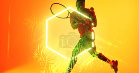 Téléchargez les photos : Joueur de tennis afro-américain souriant avec raquette et balle par hexagone éclairé et plantes. Copier l'espace, composite, sport, compétition, forme, nature, jeu, match et concept abstrait. - en image libre de droit