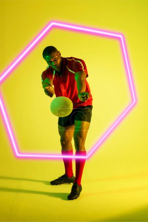 Photo for Illuminated hexagon over african american male rugby player throwing ball on green background. Copy space, composite, sport, competition, shape, playing, match and abstract concept. - Royalty Free Image