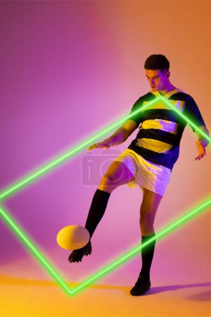 Photo for Caucasian male rugby player kicking ball by illuminated rectangle over gradient background. Copy space, composite, sport, shape, competition, playing, match and abstract concept. - Royalty Free Image