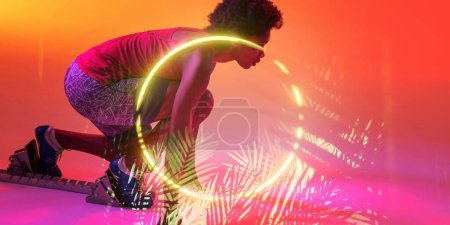 Photo for Illuminated circle and plants over african american female athlete crouching at starting position. Copy space, sprinting, sport, competition, running, racing, shape, nature and abstract concept. - Royalty Free Image