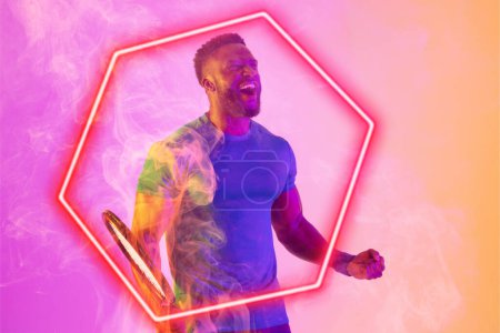 Photo for Cheerful african american male tennis player with racket screaming by illuminated hexagon. Copy space, composite, sport, shape, winner, competition, mouth open, match and abstract concept. - Royalty Free Image