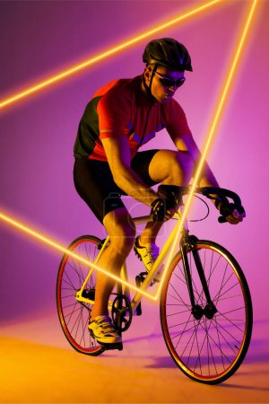 Photo for Caucasian male athlete wearing helmet and eyewear riding bike by illuminated triangle, copy space. Purple, composite, sport, cycling, racing, protection, competition, shape and abstract concept. - Royalty Free Image