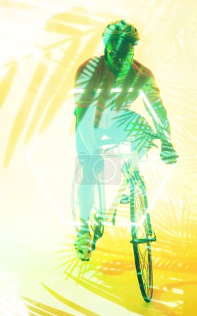 Photo for African american male cyclist riding bike with safety gear over illuminated yellow plants. Copy space, composite, sport, cycling, racing, nature, shape, competition and abstract concept. - Royalty Free Image