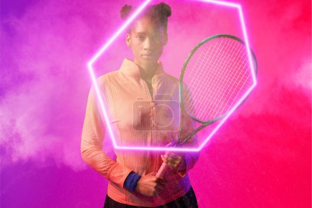 Photo for Serious african american female player with tennis racket by illuminated hexagon on smoky background. Copy space, composite, sport, shape, confident, competition, playing, match and abstract concept. - Royalty Free Image