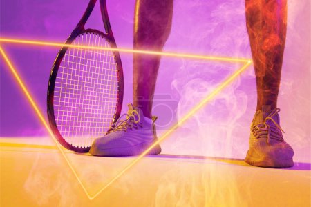 Photo for Low section of african american male tennis player wearing white shoes with racket by triangle. Copy space, composite, sport, shape, illuminated, competition, smoke, match and abstract concept. - Royalty Free Image
