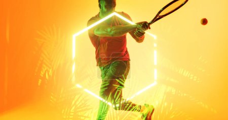 Photo for African american player playing tennis with racket and ball by illuminated hexagon and plants. Copy space, composite, sport, competition, shape, nature, playing, match and abstract concept. - Royalty Free Image