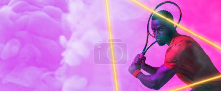 Photo for Illuminated triangle over african american male player playing tennis over purple smoky background. Racket, copy space, composite, sport, competition, shape, playing, match and abstract concept. - Royalty Free Image