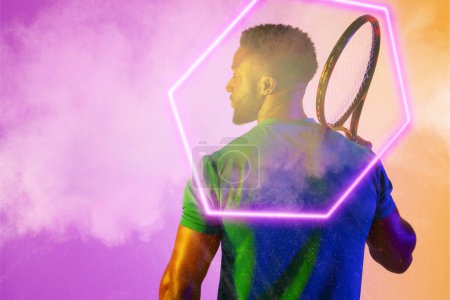 Photo for Rear view of african american male player with racket by illuminated hexagon over smoky background. Copy space, composite, sport, shape, tennis, competition, playing, match and abstract concept. - Royalty Free Image