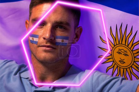 Photo for Closeup of caucasian male fan with national flag of argentina and face paint by illuminated hexagon. Copy space, composite, sport, competition, portrait, soccer, patriotism and abstract concept. - Royalty Free Image