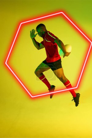 Photo for African american male player with rugby ball running by illuminated hexagon over green background. Copy space, composite, sport, competition, shape, playing, match and abstract concept. - Royalty Free Image