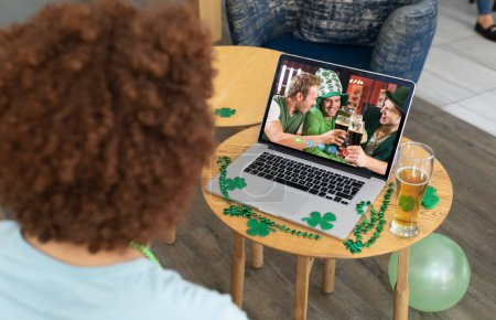 Photo for African american man having a video conference on laptop at a bar. st patricks celebration concept - Royalty Free Image