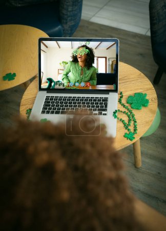 Photo for African american man having a video conference on laptop at a bar. st patricks celebration concept - Royalty Free Image