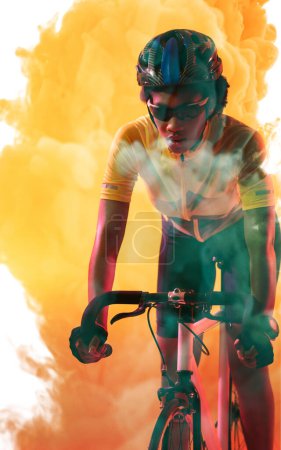 Téléchargez les photos : African american female athlete wearing helmet and eyewear riding bike over yellow smoky background. Confident, copy space, composite, sport, cycling, racing, competition and abstract concept. - en image libre de droit