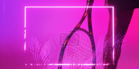 Téléchargez les photos : Cropped leg of african american male player with tennis racket over illuminated plants and rectangle. Copy space, composite, sport, competition, shape, nature, purple, match and abstract concept. - en image libre de droit