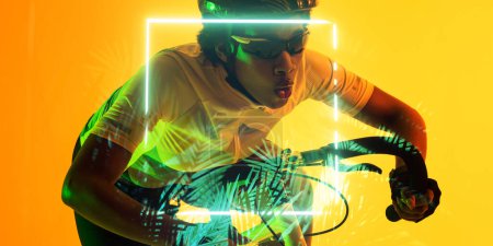 Téléchargez les photos : African american woman wearing eyewear and helmet riding bike by glowing square and plants. Copy space, composite, sport, cycling, racing, competition, nature, shape, illuminated, mouth open. - en image libre de droit