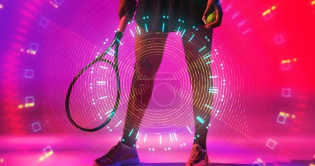 Téléchargez les photos : Low section of biracial female tennis player with racket and ball over illuminated circular pattern. Copy space, composite, sport, competition, neon, hand, leg, shape and abstract concept. - en image libre de droit