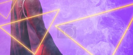 Photo for Midsection of african american basketball player holding ball by triangles on smoky background. Copy space, composite, illuminated, hand, sport, competition, illustration, shape and abstract concept. - Royalty Free Image