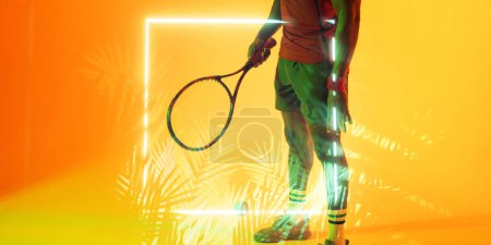 Téléchargez les photos : Illuminated plants and square over low section of african american male tennis player with racket. Copy space, composite, sport, competition, shape, nature, playing, yellow, match and abstract. - en image libre de droit