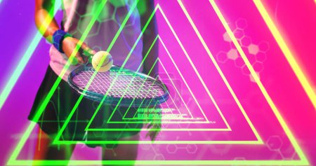Photo for Midsection of biracial female tennis player practicing with racket and ball over triangular shape. Illuminated, copy space, composite, sport, competition, playing, neon, hand and abstract concept. - Royalty Free Image