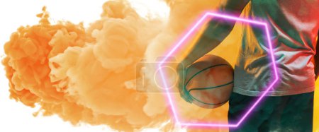 Photo for Midsection of biracial basketball player holding ball with hexagon over smoky background. Composite, copy space, rear view, hand, illuminated, sport, competition, illustration, shape and abstract. - Royalty Free Image