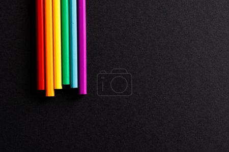 Foto de Close up of rainbow coloured pencils with copy space on black background. Pride month, equality, lgbt and human rights concept. - Imagen libre de derechos