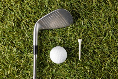 Photo for White tee, golf ball and golf club on grass with copy space. Golf, sports and competition concept. - Royalty Free Image