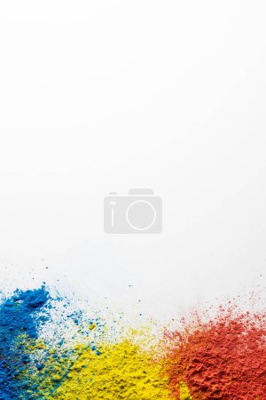 Photo for Close up of multi coloured powder and copy space on white background. Holi festival, colour, hindu tradition and celebration concept. - Royalty Free Image